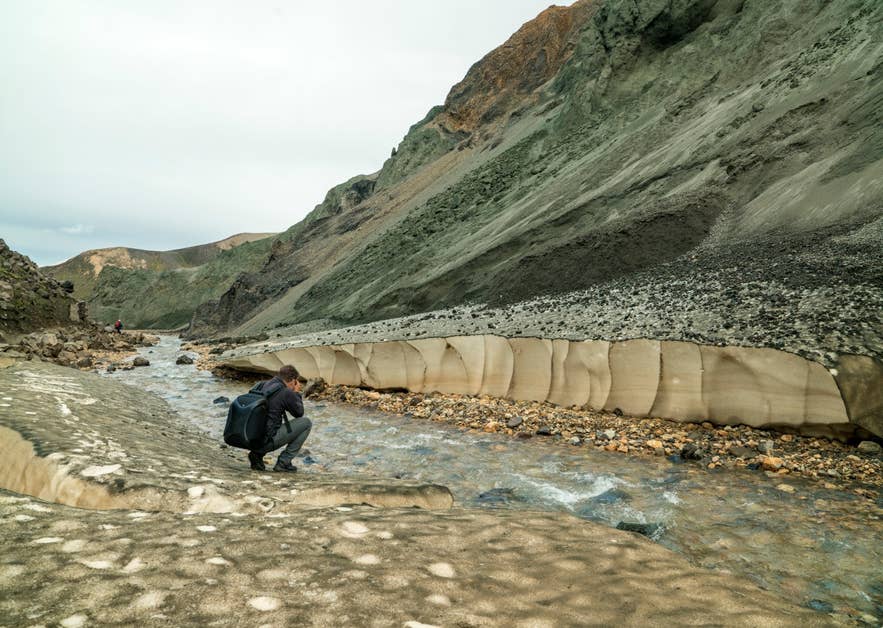 Inside Grænagil ravine at Landmannalaugar with green rhyolite walls and a stream