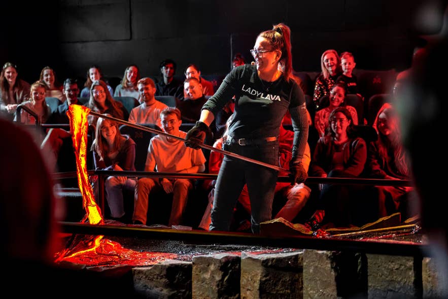 Presenter pouring real molten lava at the Lava Show in Reykjavik, a top-rated rainy-day activity for kids.