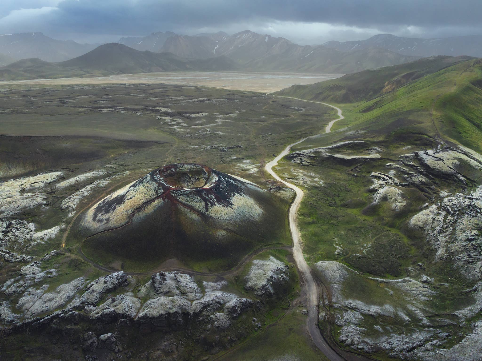 Aerial view of Stutur Crater beside a gravel road near Landmannalaugar in the Highlands of Iceland.