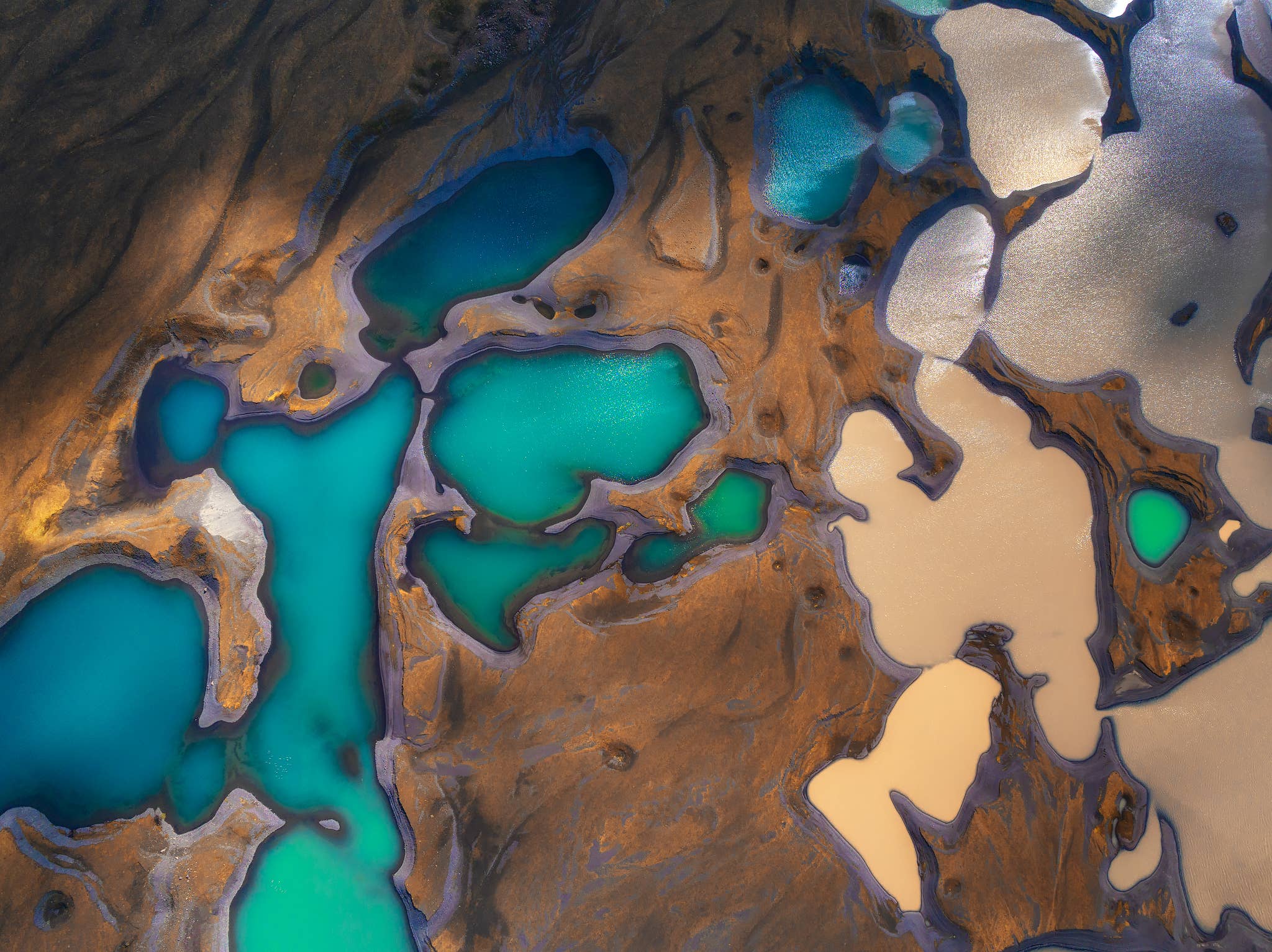 Aerial view of turquoise and silty glacial pools in the Highlands of Iceland.