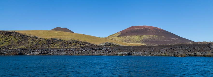 Helgafell and Eldfell volcanoes above the lava coast of Heimaey