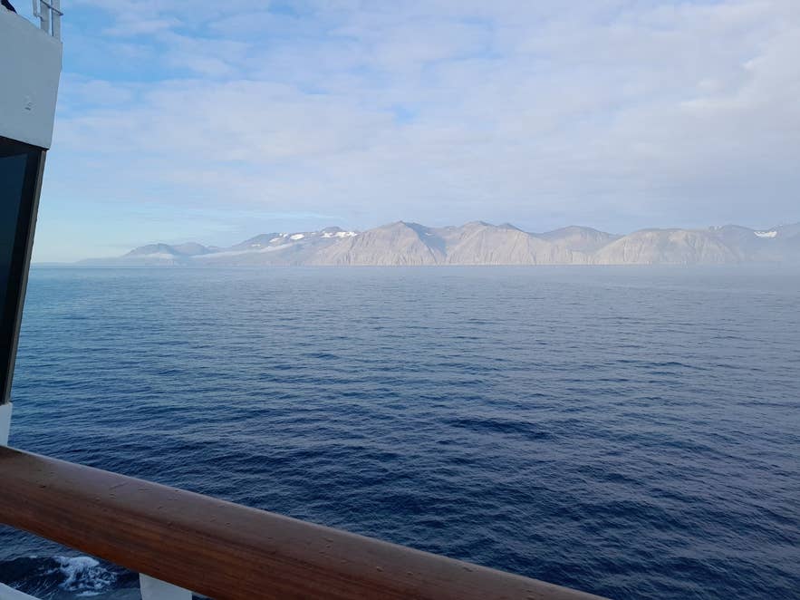 The Víknafjöll mountain wall on the western shore of Skjálfandi Bay from a boat