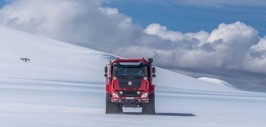 Sleipnir Tours red Tatra glacier truck on the snow of Langjökull glacier, used for Neptune Ice Cave tours from Gullfoss