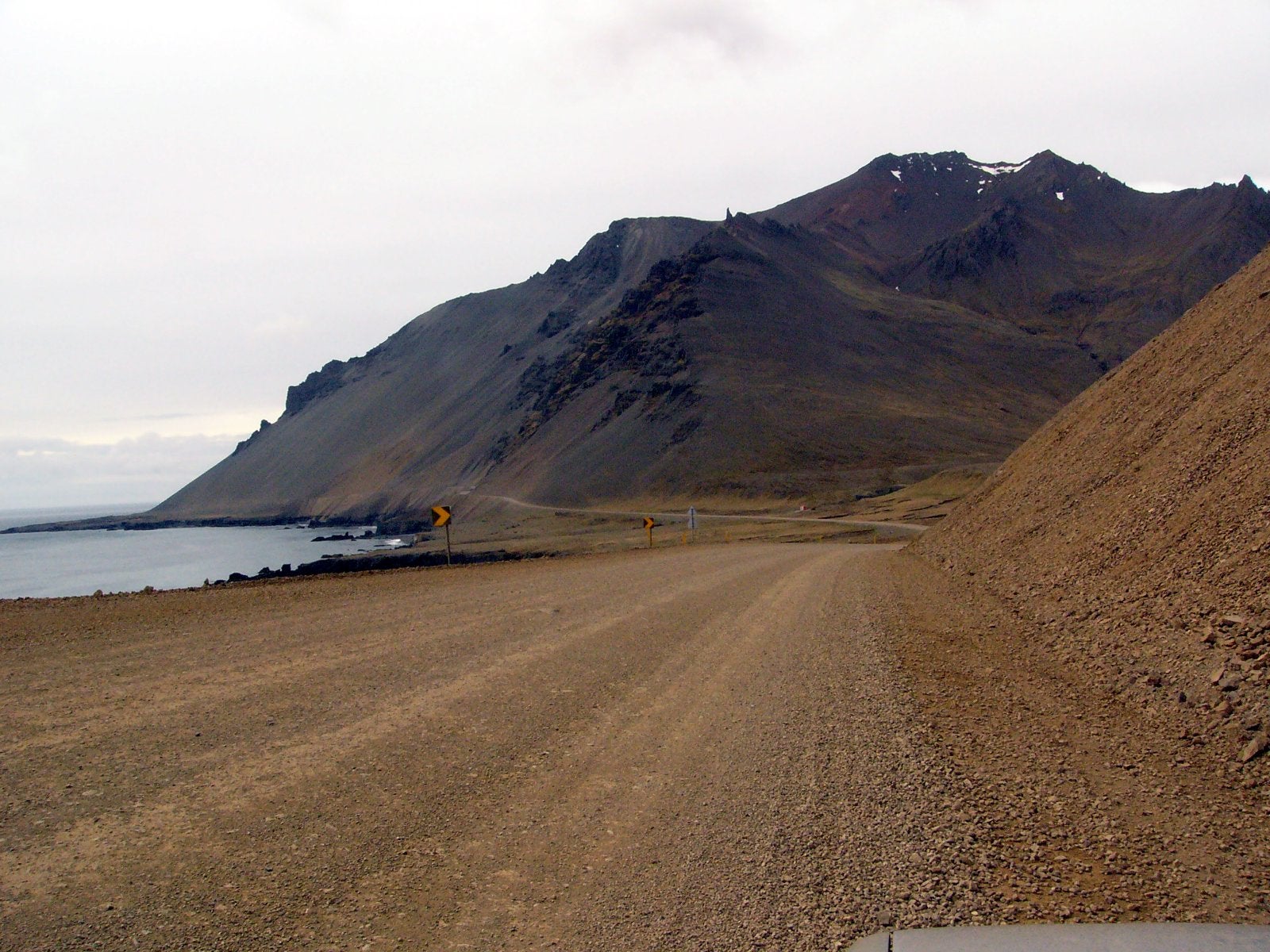 The Ring Road crossing the Hvalnesskriður scree slopes in East Iceland, with pale rhyolite mountains behind