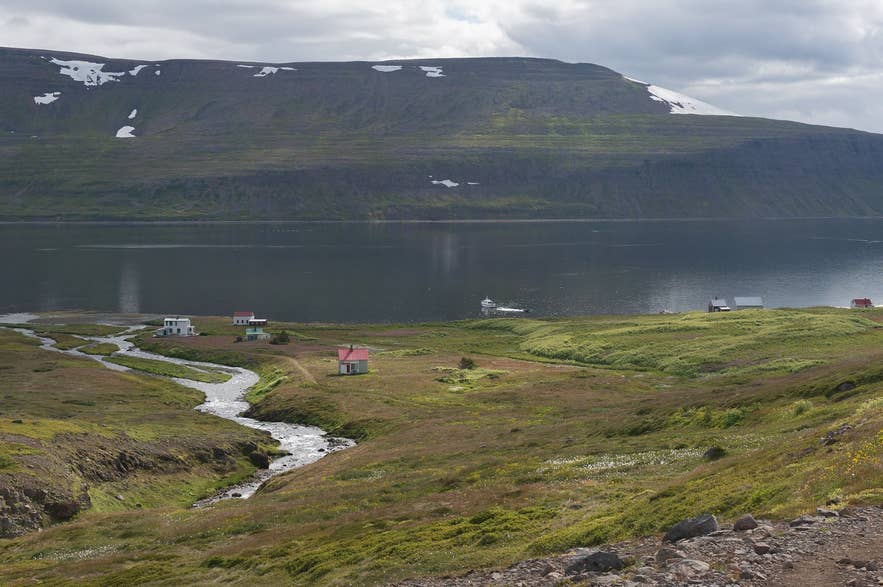 Summer houses of the abandoned village of Hesteyri on Hesteyrarfjörður, where the Hesteyrarskarð trail starts Summer houses of the abandoned village of Hesteyri on Hesteyrarfjörður, where the Hesteyrarskarð trail starts