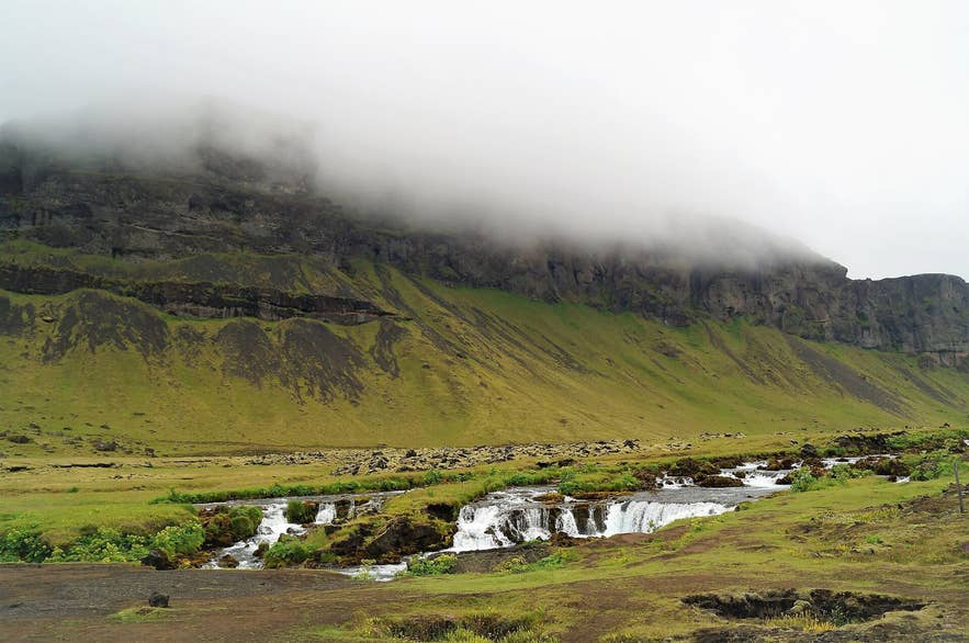 Fossálar waterfalls tumbling over mossy lava below the Síða cliffs beside Route 1, South Iceland