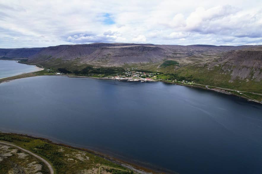 Tálknafjörður village with the pale sand spit of Sveinseyri extending into the fjord to its west Tálknafjörður village with the pale sand spit of Sveinseyri extending into the fjord to its west