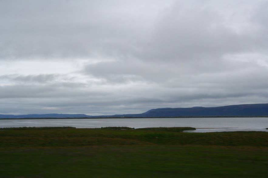 Skjálftavatn lake in Kelduhverfi with flat rift-zone land and hills behind, seen from Route 85