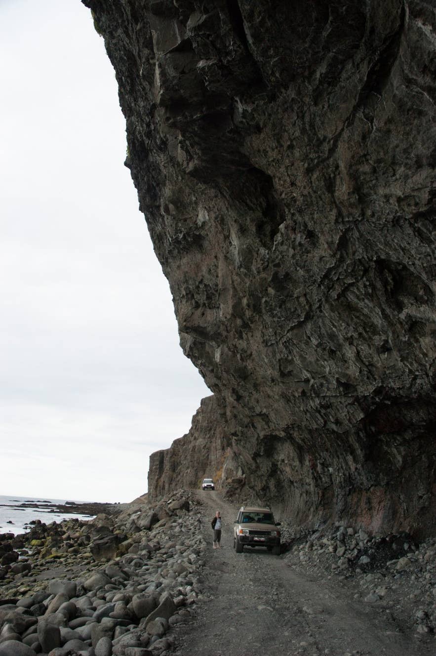 Kjaransbraut track squeezed between cliff and sea on the Arnarfjörður side of the Svalvogar peninsula