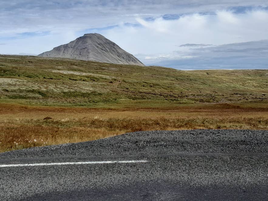 Route 60 climbing Brattabrekka pass with the cone of Baula behind