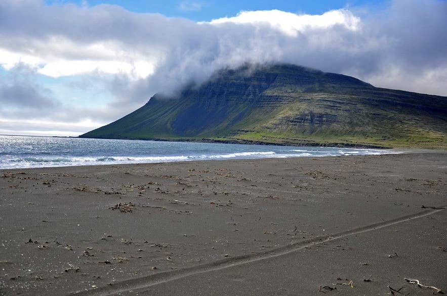 Black sand beach at Vöðlavík under cloud-capped mountains in the Eastfjords Black sand beach at Vöðlavík under cloud-capped mountains in the Eastfjords