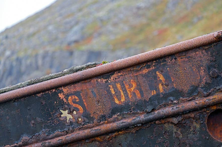 Rusted bow of the Suðurland shipwreck at Djúpavík with the ship's name still visible