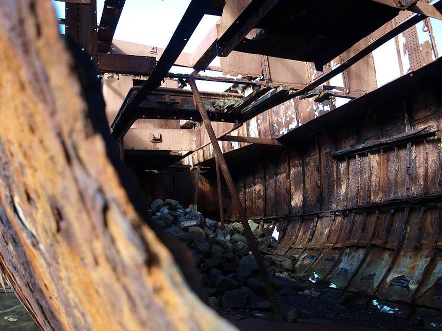 Inside the rusted hull of the Suðurland shipwreck at Djúpavík