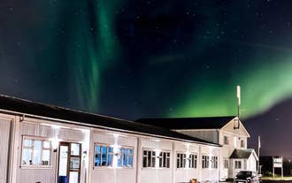 Behold the enchanting spectacle of the hostel under the mesmerizing glow of the northern lights.