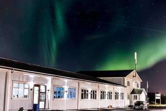 Bewonder het betoverende schouwspel van het hostel onder de magische gloed van het noorderlicht.