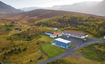 Een luchtfoto van Soti Lodge in een schitterende bergachtige omgeving op het schiereiland Tröllaskagi.