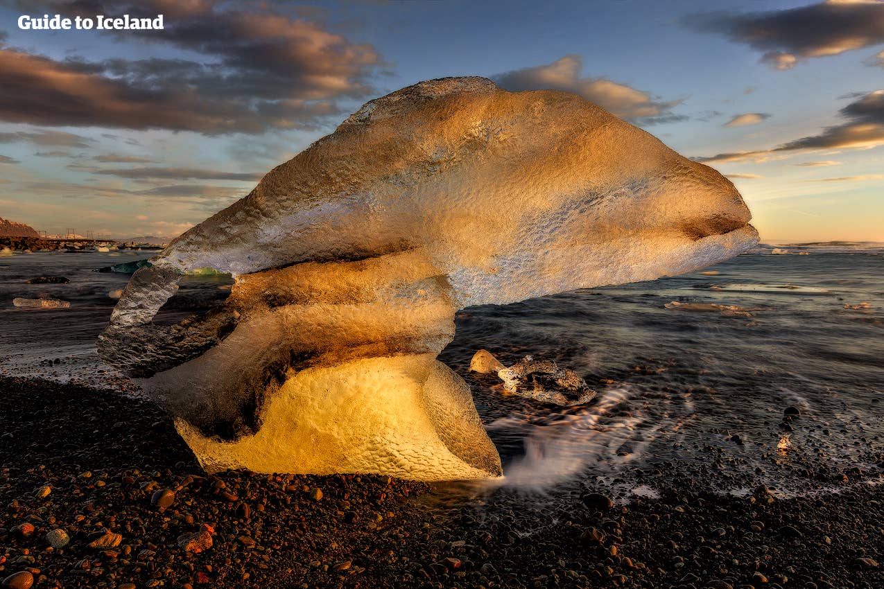 The sun makes the ice look golden in Jökulsárlón glacier lagoon in Iceland