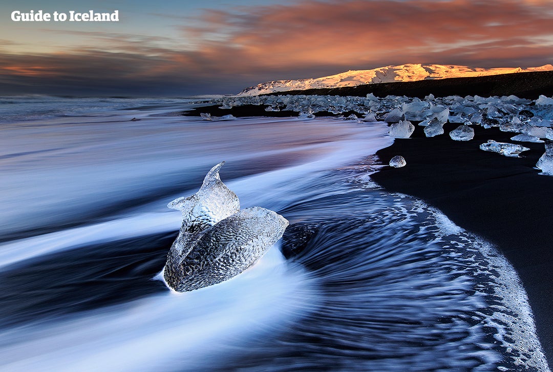 Interplay between the icebergs and the sea at black sandy beaches by Jökulsárlón in Iceland