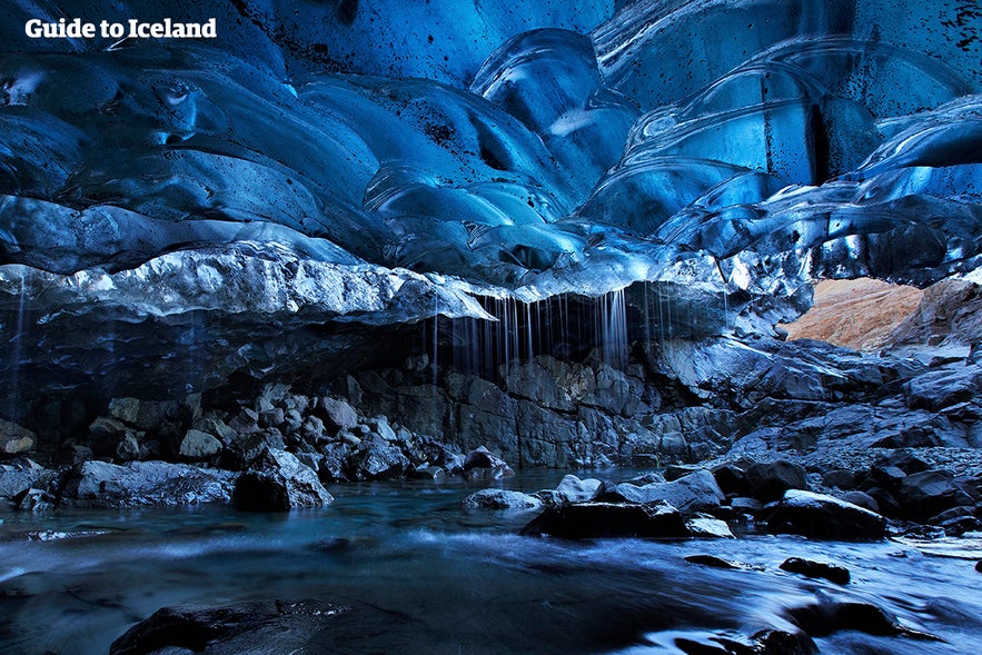 Interior of an ice cave with blue ice and long icicles