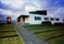 The Nordic House's curved blue roof is made to resemble the mountainous backdrop.