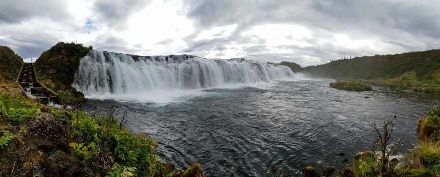 Faxafoss Waterfall in Iceland with scenic river views, lush greenery, and nearby attractions like Skalholt and Thingvellir.