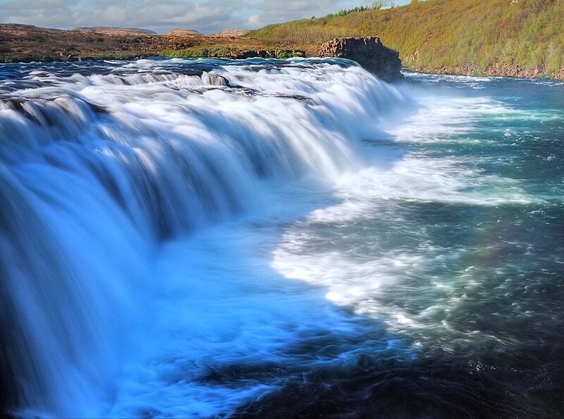 Faxafoss Waterfall in Iceland with turquoise waters and lush surroundings near Thingvellir and Skalholt on the Golden Circle.