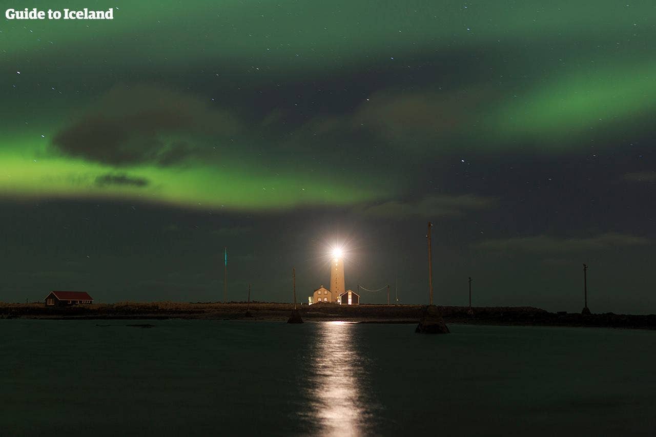 Northern Lights and a lighthouse in Reykjavík city in Iceland