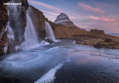 Kirkjufellsfoss waterfall boasts an epic setting with Kirkjufell mountain as its backdrop.