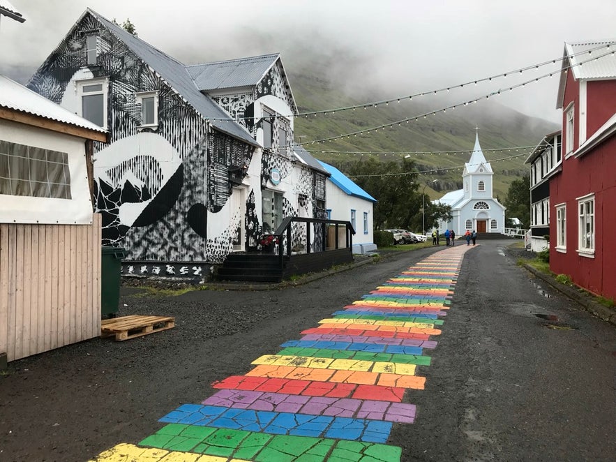 A rainbow colored road leads to Seydisfjordur.