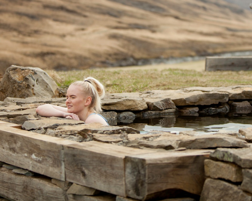 Relax in an outdoor hot tub with fantastic views at the Wilderness Center in East Iceland.