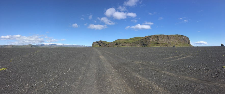 Hjorleifshofdi surrounded by black sands.