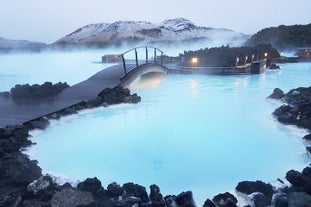 A bridge leads across the milky-blue waters of the Blue Lagoon geothermal spa in Southwest Iceland.