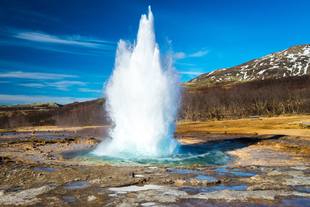 Strokkur geyser erupts with a dramatic force on the Golden Circle of Iceland.
