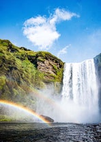 A beautiful rainbow creates a perfect contrast to the raw power of Skogafoss waterfall.