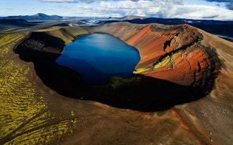 Inside Kerid crater is a tranquil lake, the turquoise water contrasting perfectly against the vibrant red walls.