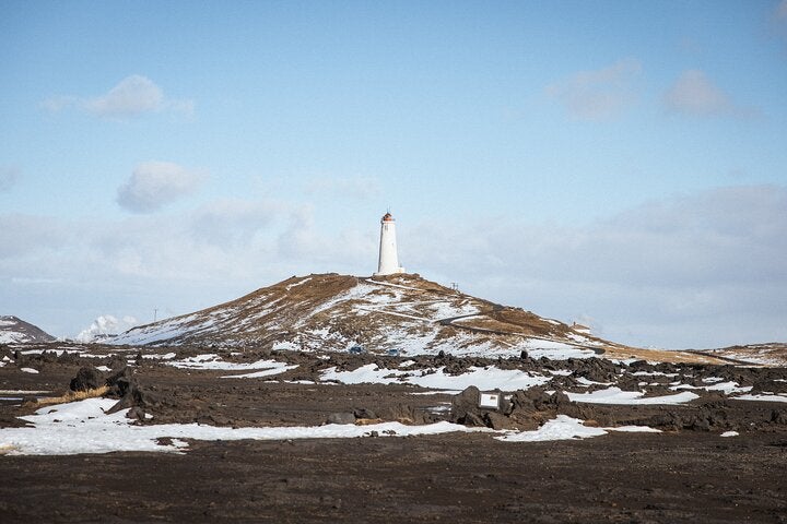 A lighthouse stands on top of a hill on the Reykjanes peninsula.