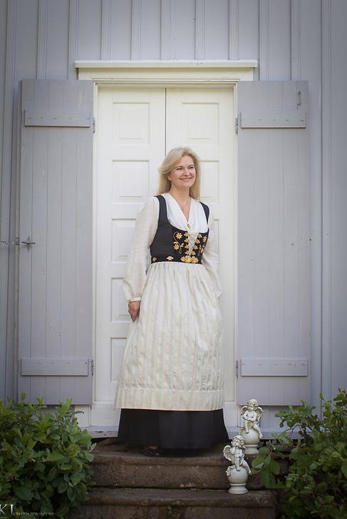 Sigrún Þormar in a national costume at Fitjakirkja church