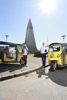 Guests strike a pose with their tuk-tuks and the Hallgrimskirkja church in the background.