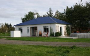 Jadar Farm, a white, single-storey cottage.
