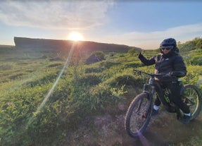 A person on an e-bike tour in North Iceland puts their thumb up to the camera.