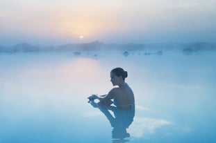 A woman relaxing in the Blue Lagoon geothermal spa in Iceland.