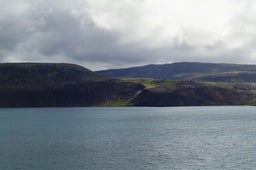 Heidarvatn lake in South Iceland is a tranquil fishing destination surrounded by rugged landscapes, offering anglers a serene retreat amidst nature's beauty.