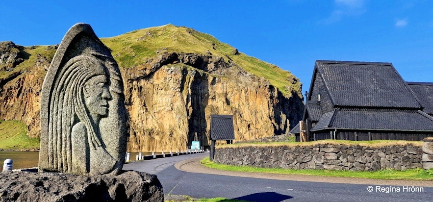 The Stafkirkjan church is in the Skansinn area at the harbor amid tranquil waters and dramatic hills.