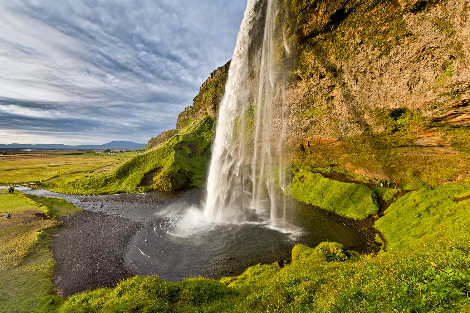 Serenity can be found in South Iceland by walking around the gentle cascade of Seljalandsfoss in summer.
