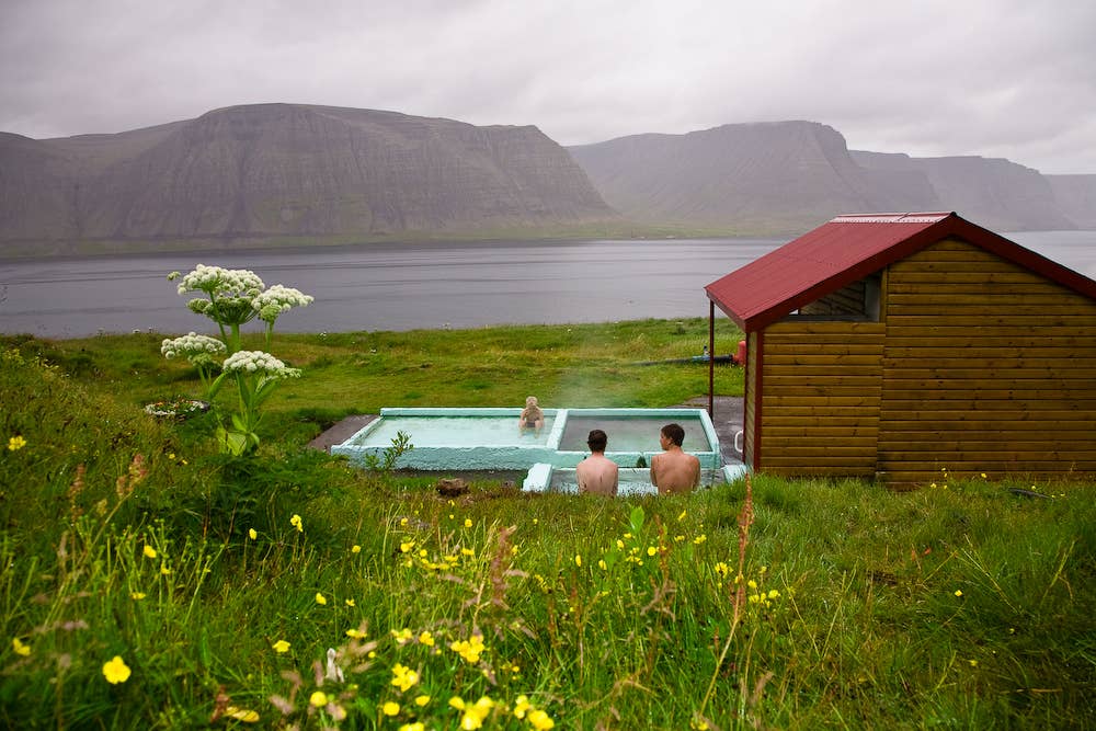 Pollurinn hot pool in the Westfjords has a scenic location along a fjord.
