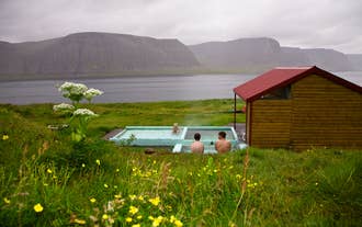 Pollurinn hot pool in the Westfjords has a scenic location along a fjord.