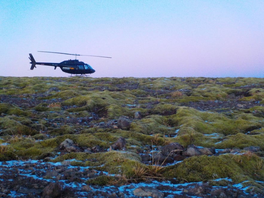 Helicopter surrounded by sunset sky on top of Mt Esjan