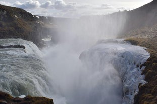 The misty splendor of Gullfoss waterfall seen from above, illustrating the raw beauty of Iceland’s nature.