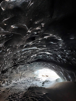 The light filtering into the Askur ice cave creates beautiful effects for photographers.