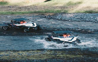 Buggy vehicles crossing shallow rivers in South Iceland.